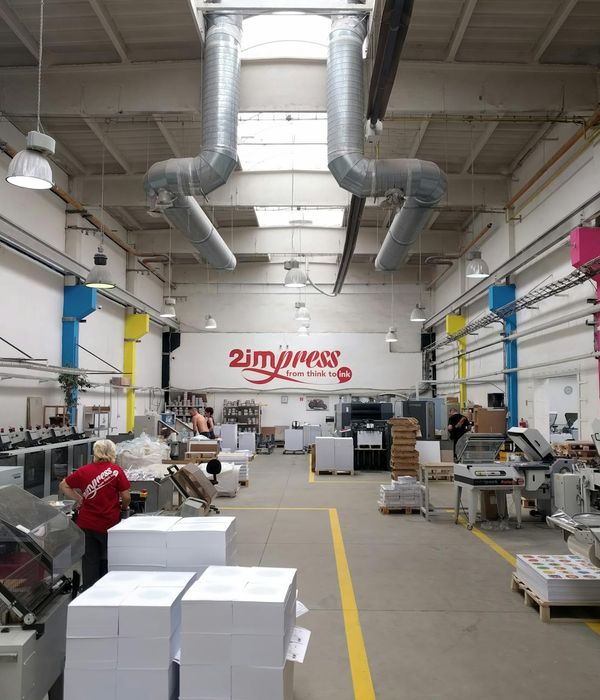 Industrial production facility with advanced manufacturing equipment and workers