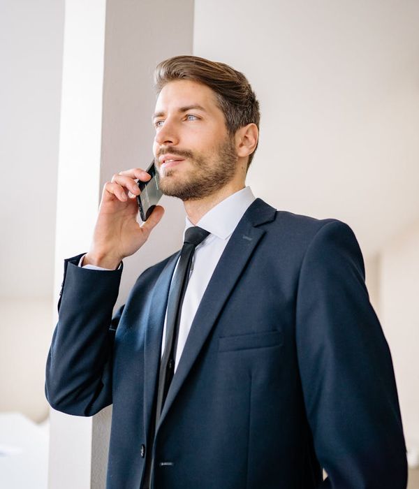 Man in formal business attire with confident professional demeanor