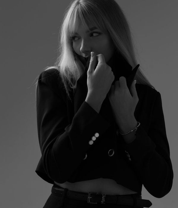 Woman in contemporary professional clothing with sophisticated and thoughtful expression